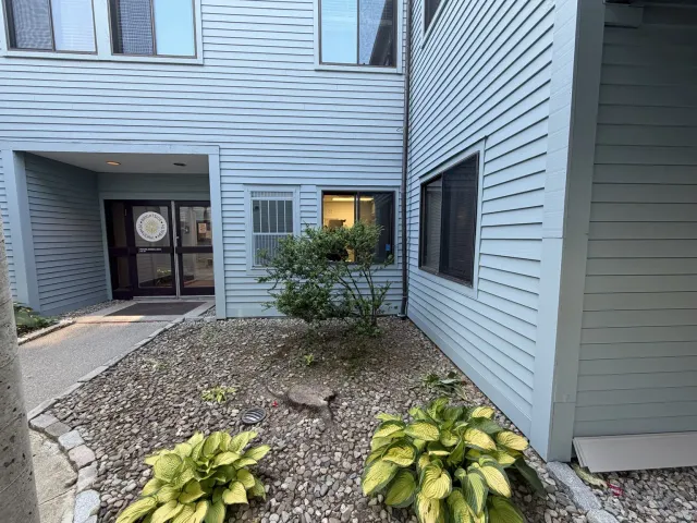 Completed exterior wall rebuild with restored siding and window trim in Warwick Rhode Island