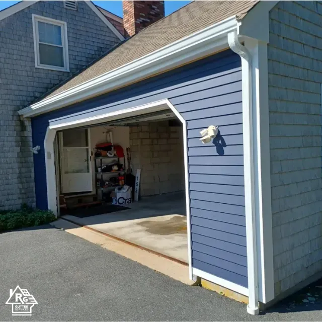 A blue garage with a white trim and a sign that says r & w