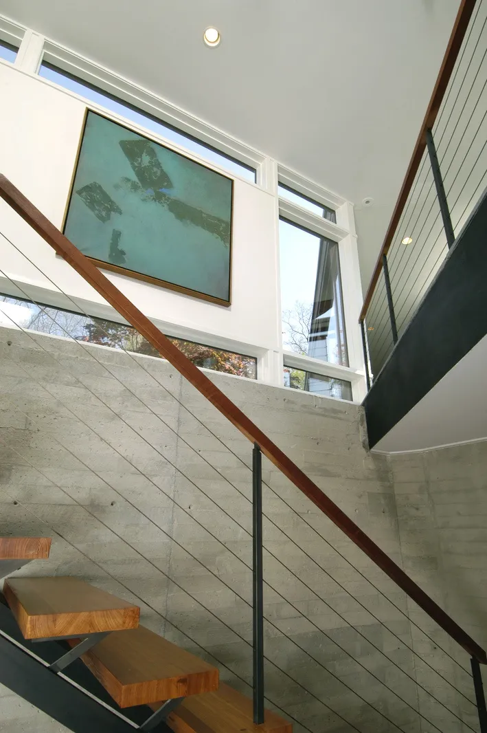 Floating stair with board-formed concrete and steel