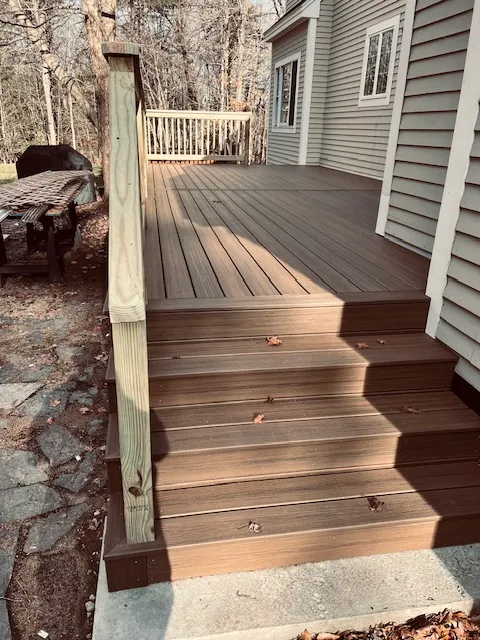 Trex deck rebuild with wooden railing in Goffstown