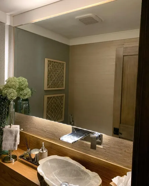 Wall mirror installed above a bathroom vanity