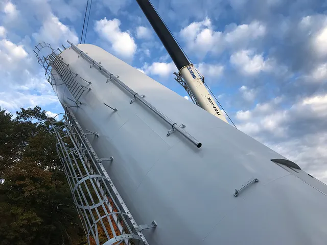 Large storage tank installation, almost complete – our crane is holding the tank while the other operator stands the tank upright