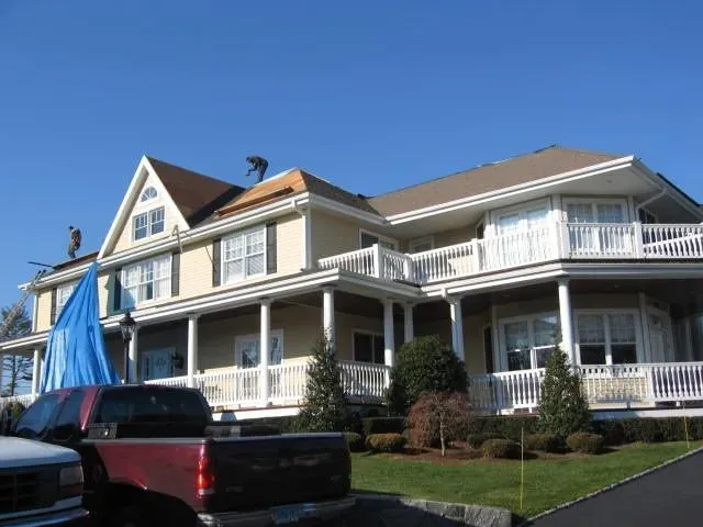 A large house with a truck parked in front of it