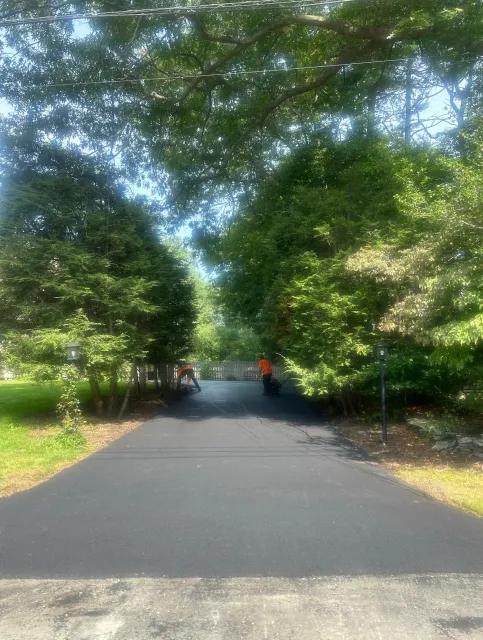 A man doing sealcoating in Cape Cod, MA - Cape Cod Paving hard at work