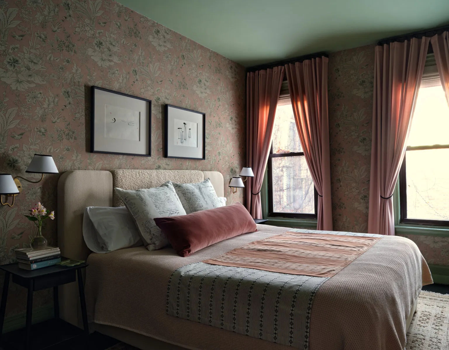 A bedroom with a bed and two windows