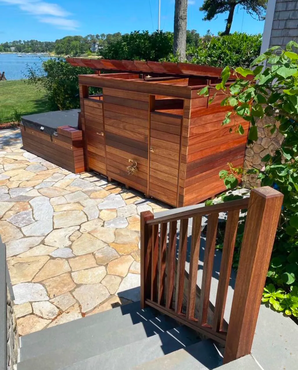 Wood deck with integrated spa and waterfront view