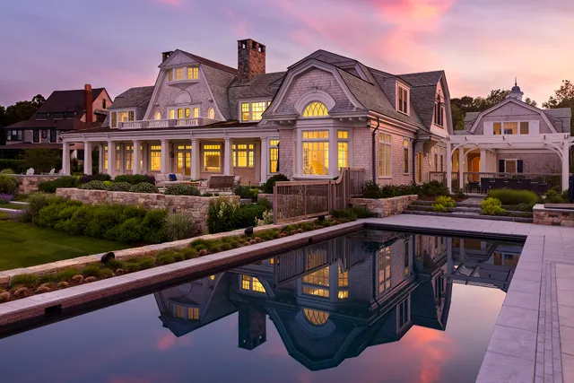 Terraced stone walls, pool and layered plantings at dusk