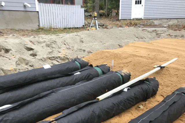A group of poles sitting on top of the ground.