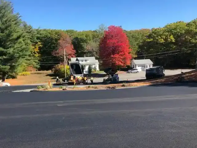 A close-up view of a freshly paved asphat parking lot, with a smooth and even surface.