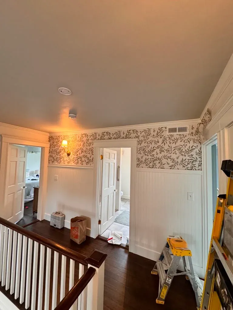 Hallway wallpaper installation above wainscoting