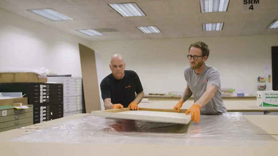 Crew blanket-wrapping furniture with care