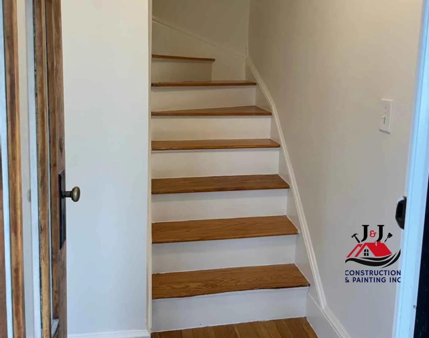 Refinished stair treads with freshly painted risers and trim