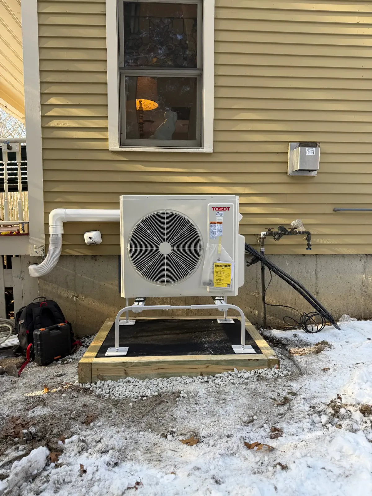 Finished Tosot outdoor condenser on a stand at a Massachusetts home