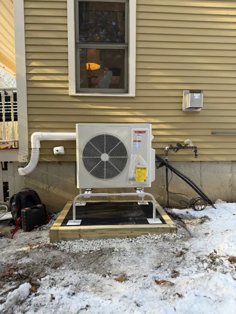 Finished Tosot outdoor condenser on a stand at a Massachusetts home