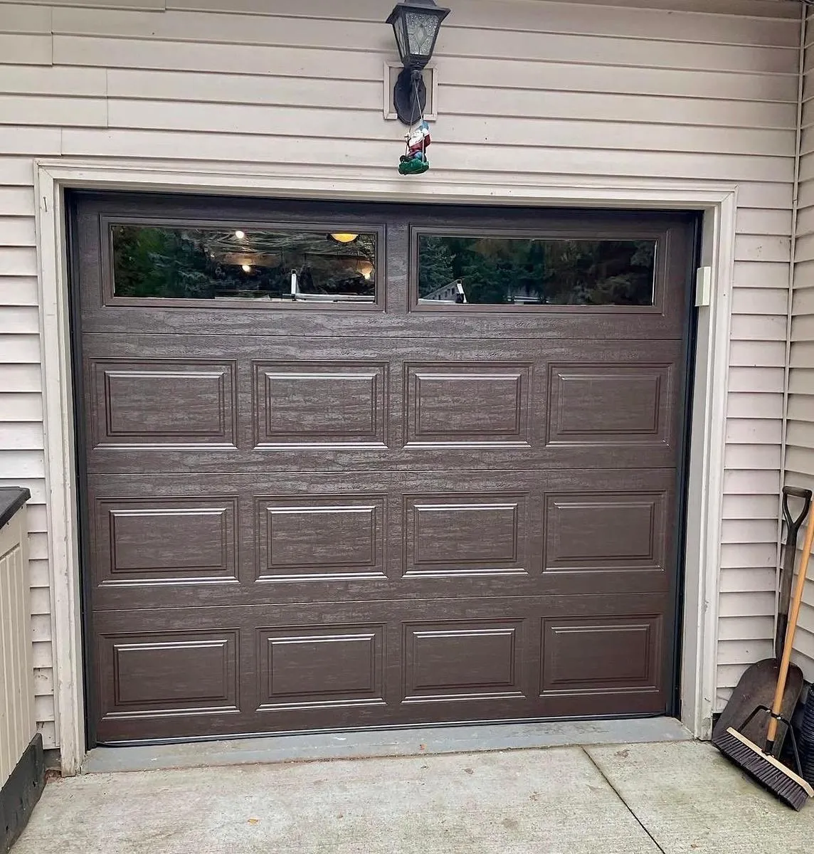Bluefin dark wood-look garage door with windows installed