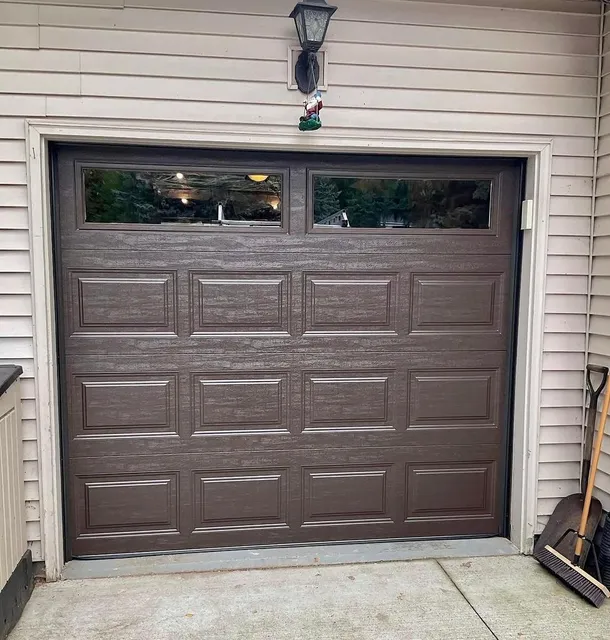 Bluefin dark wood-look garage door with windows installed