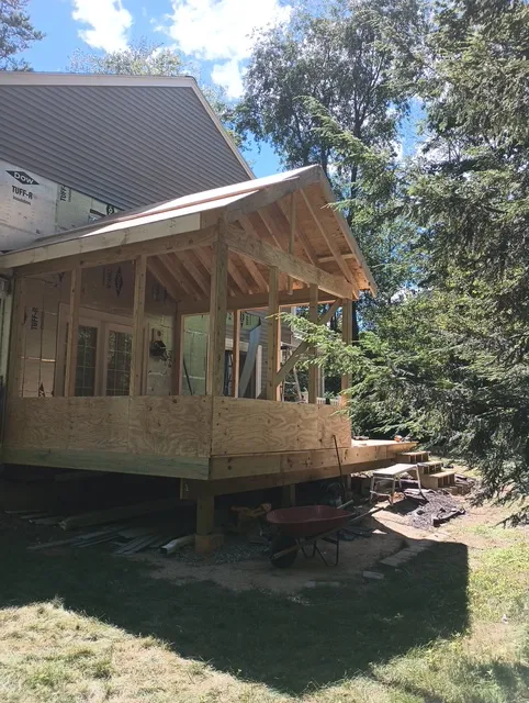 Side framing view of the Bedford four-season porch addition tied into the rebuilt deck
