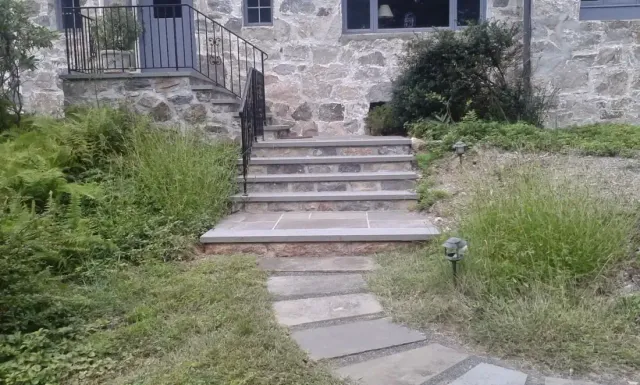 Stone veneer house front with bluestone steps and a stone walkway