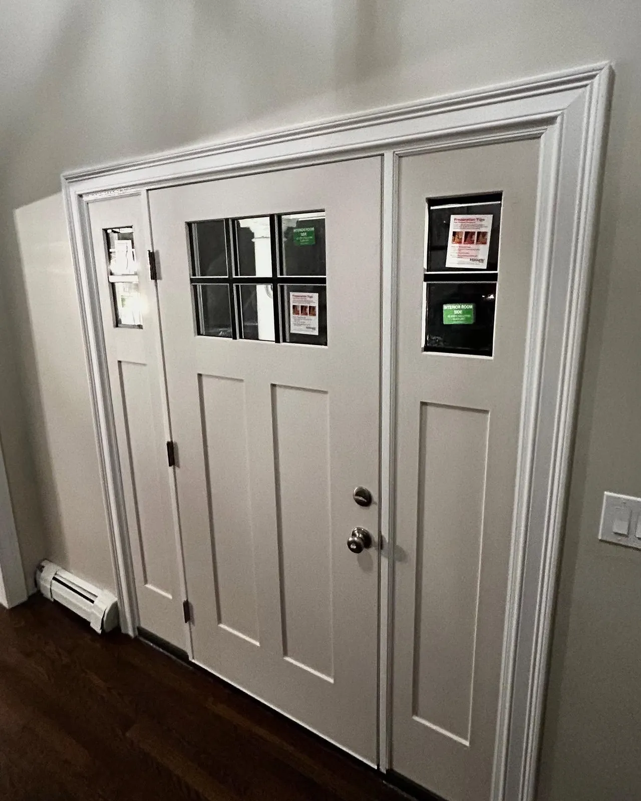 Newly installed craftsman entry door with sidelights