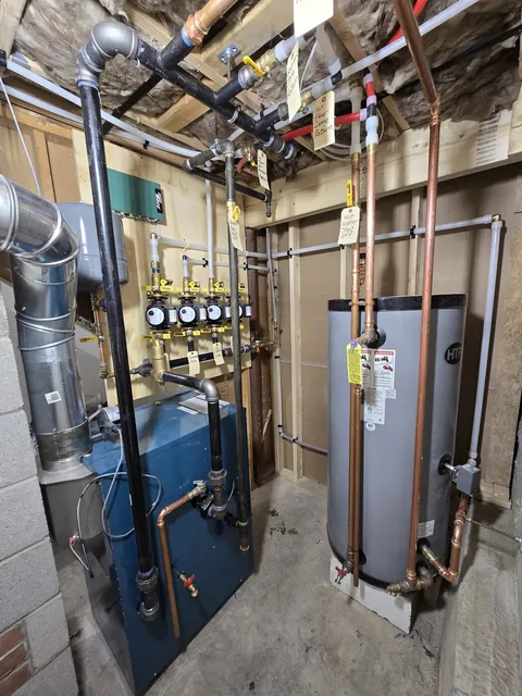 Basement mechanical room with a boiler, indirect water heater and labeled copper piping