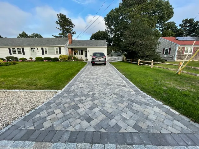 Paver driveway in herringbone with granite cobblestone apron, Cape Cod MA