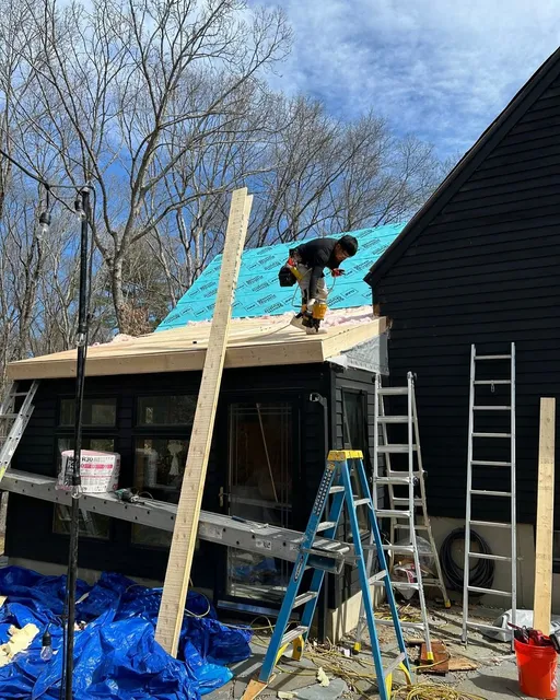 Crew installing metal roof