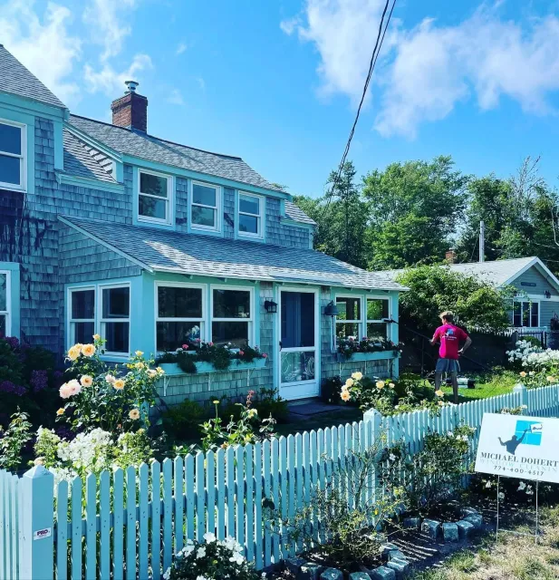 Professional window cleaning service at Cape Cod home with flower garden | Window washing Cape Cod