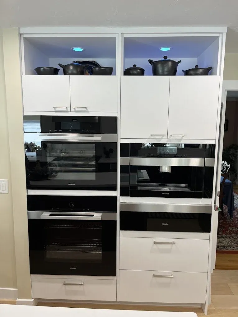 interior cabinet recessed lighting installed in the open upper cabinets of a kitchen and casting a light blue hue