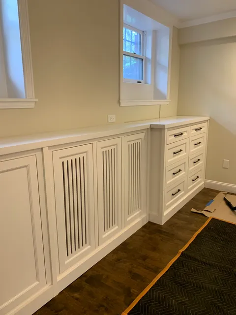 Built-in radiator cover and cabinet run under a window