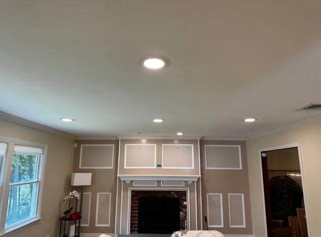 Living Room with Recessed Lighting and Unfinished Wall Frames Around the Fireplace