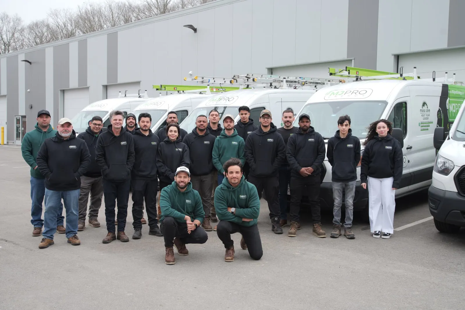 MJ Pro Energy team standing in front of their service vans
