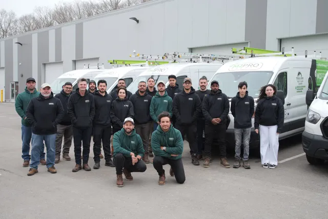 MJ Pro Energy team standing in front of their service vans