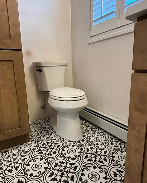 Completed bathroom with patterned tile floor