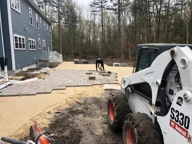 A bobcat s330 is parked in front of a house.