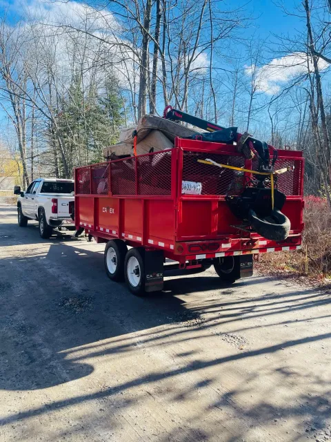 Finally Freedom Junk Removal's truck hauling away junk from a client