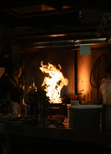 Active kitchen fire with flames near the stove before fire and smoke damage restoration in Hampden County, MA
