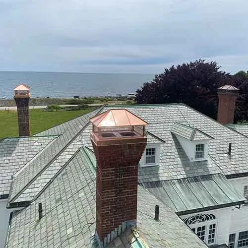 Frechette Chimney - After Chimney Repair was completed on masonry brick chimney and copper chimney caps were installed