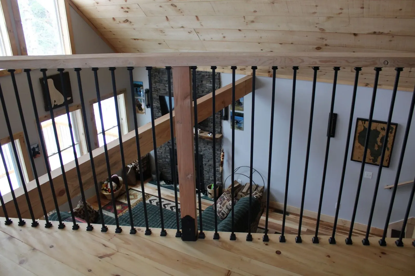 A wooden staircase with a wrought iron railing