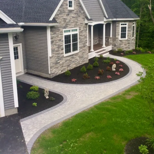 Hollandstone paver walkway connecting a driveway to the front door