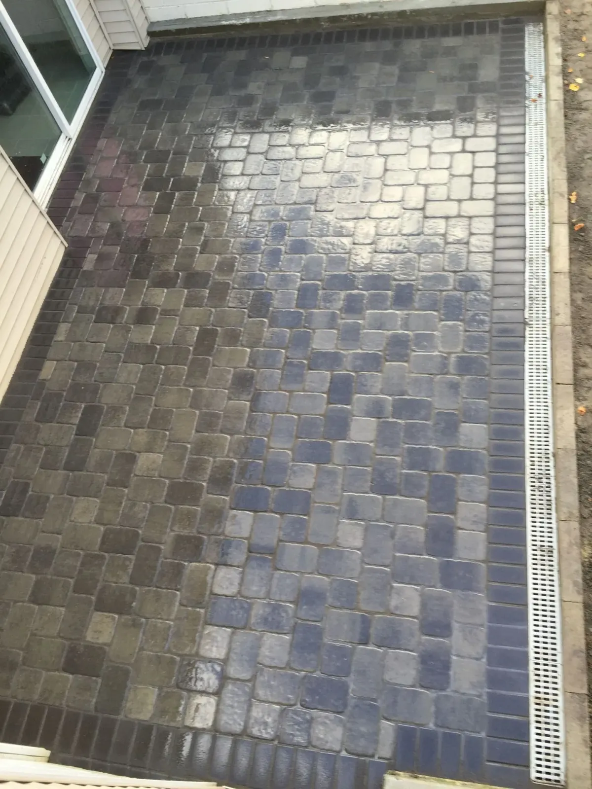 An aerial view of a brick patio with a drain.