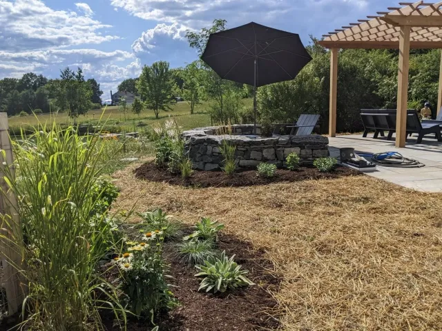 A freshly installed patio & Panton stone seating wall. Stone by Champlain Landworks; Pergola by Chuck Wolanin.