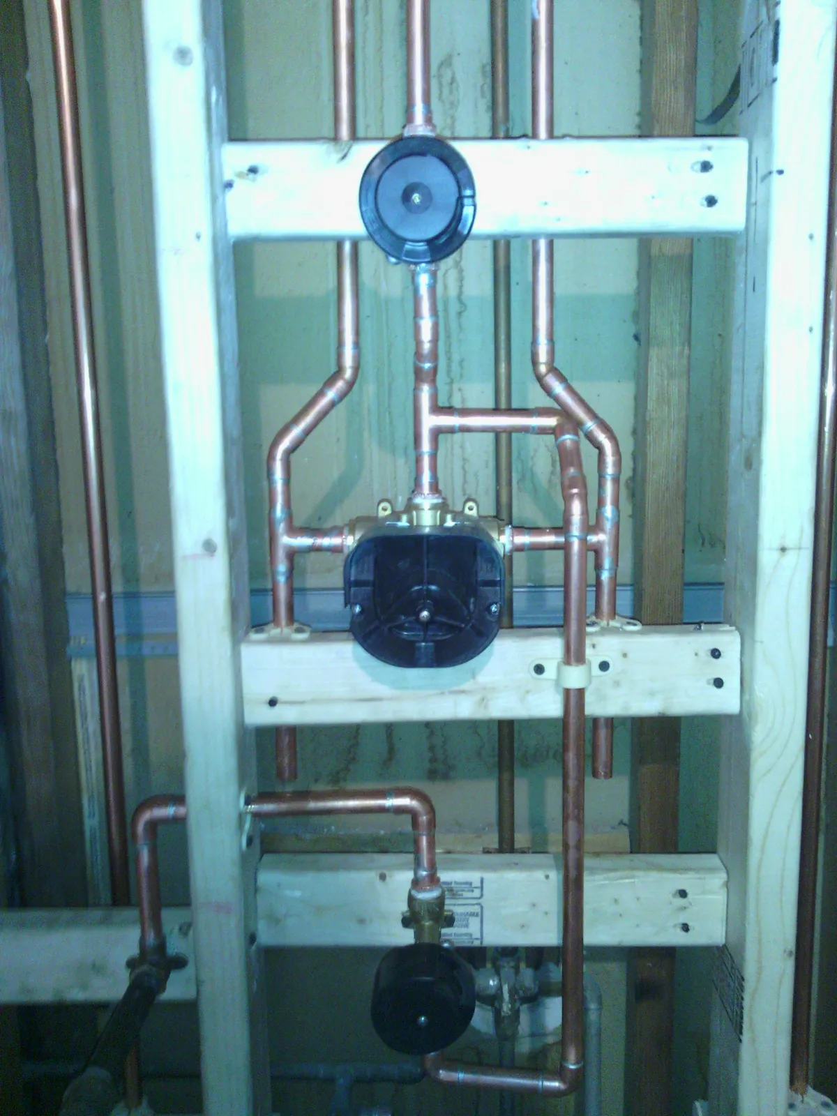 Copper supply manifold and circulator roughed into a stud bay