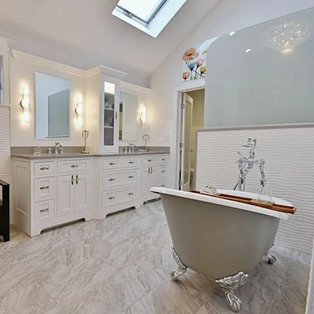 Bathroom with white cabinets, a clawfoot tub, and a decorative window.