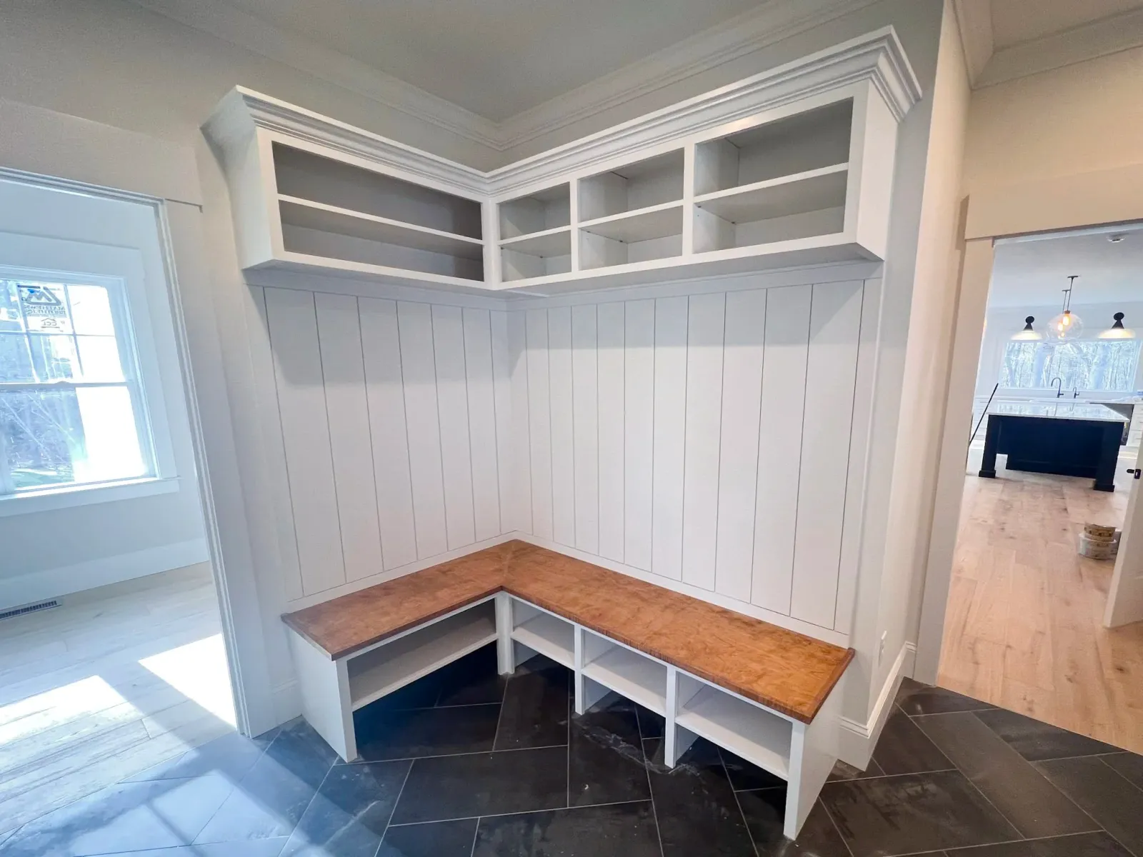 Custom built-in bench and shiplap wall paneling installed by Reimagined Joinery.