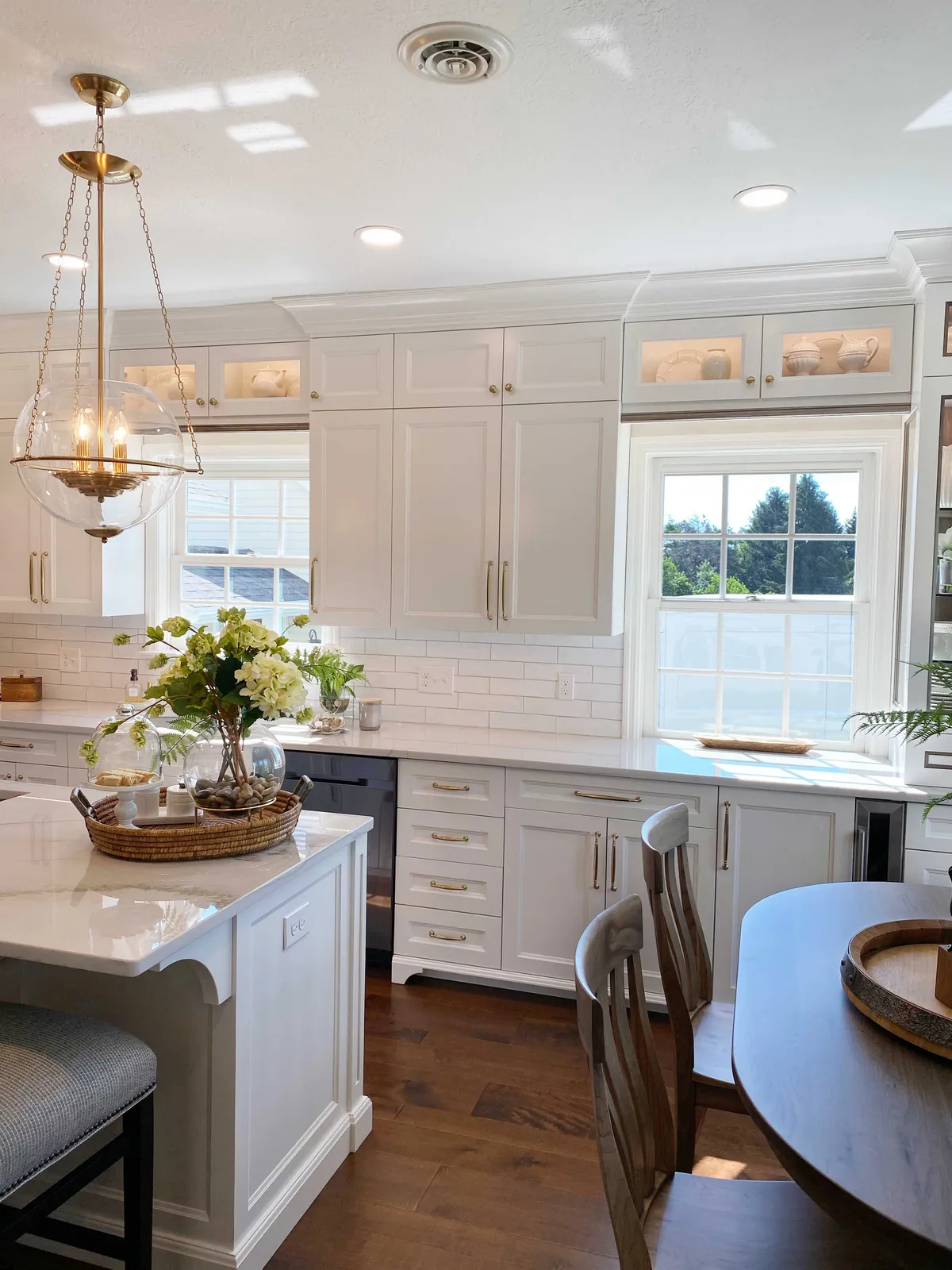 Haute Designs Kitchen & Bath. Interior Design. White, frameless custom cabinets by Elmwood Cabinetry. Cabinet features: Decorative posts, glass doors, cabinet lighting, corbels.