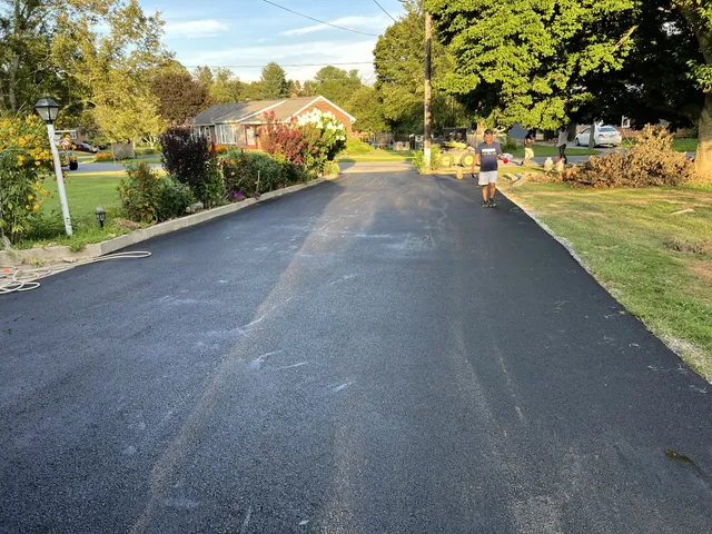 Freshly paved asphalt driveway in New Hampshire at golden hour