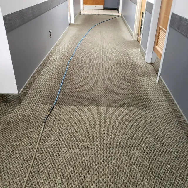 a long hallway with a hose going down it
