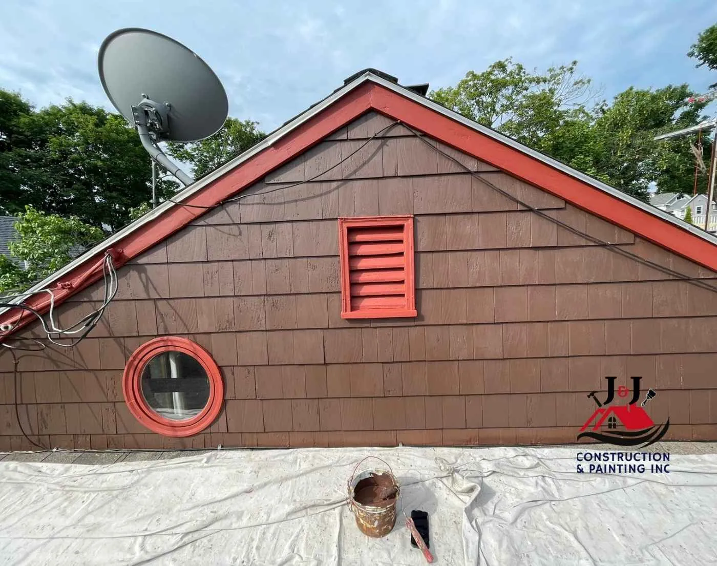 Exterior shingle and trim painting on a gable end