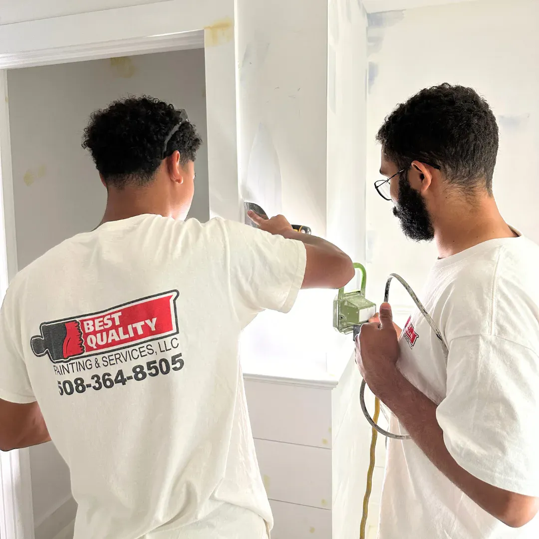 Professional interior painting with smooth roller application on a bright residential wall.
