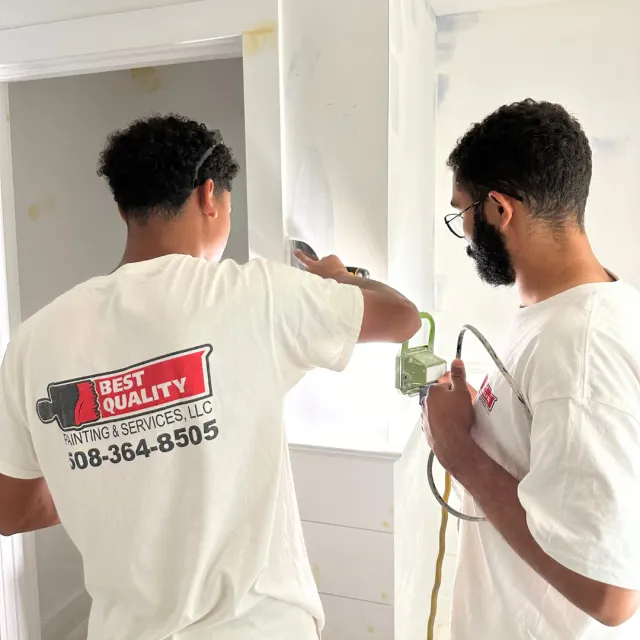 Professional interior painting with smooth roller application on a bright residential wall.